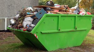 Green skip bin full of rubbish